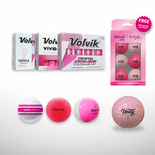 Volvik brand BCRF golf balls and packaging on a light gray background, including boxed Volvik VISTA3 and Crystal Combi balls, a pink Volvik BCRF Unity 6 ball pack with a free badge, and four loose golf balls in white, pink, and translucent pink.