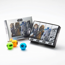 Star Wars golf ball gift set featuring a silver outer sleeve with a clear display window and a black inner tray containing four character-themed golf ball boxes featuring Han Solo, Chewbacca, R2-D2, and the Millennium Falcon.