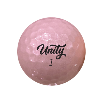 A single pink golf ball with a textured dimple pattern, featuring the black printed logo 'Unity' and the number '1' on its surface, isolated on a white background.