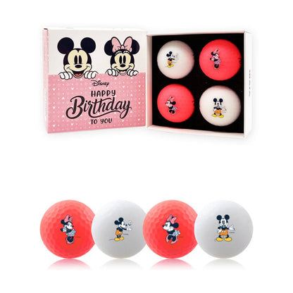A set of golf balls with Mickey and Minnie Mouse designs in a box, along with two additional golf balls with 'Happy Birthday' and Disney branding on them, displayed on a yellow background with birthday decorations.